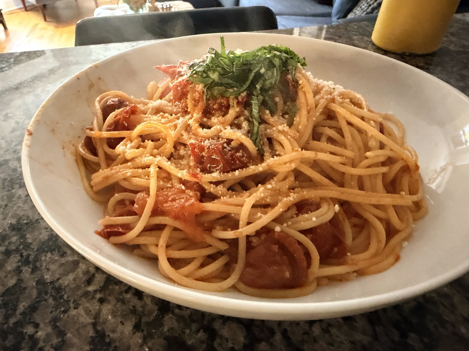 Cherry tomato pasta plated, with basil and parmesan